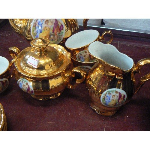 192 - GOLD GILT TEA SET WITH GRECIAN STYLE FIGURE DETAIL (1 CUP HANDLE NEEDS A REPAIR)