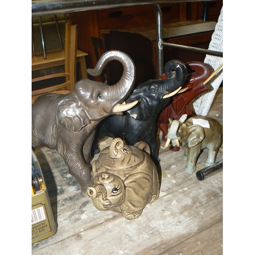 246 - COLLECTION OF 4 ELEPHANTS[SOME DAMAGED TUSKS] AND AN ELEPHANT TEAPOT.