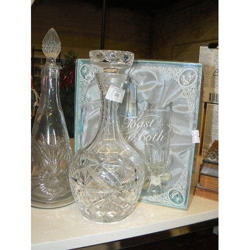 190 - 2 GLASS DECANTERS WITH STOPPERS, TOGETHER WITH SILVER WEDDING FLUTES GIFT-SET. APPEARS NEW.