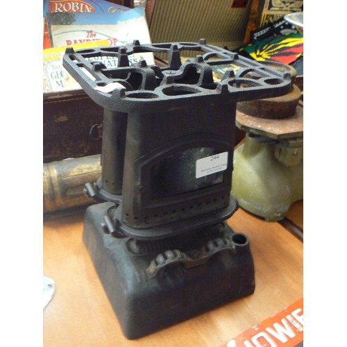 244 - TINY BEATRICE CAST IRON PARRAFIN STOVE, WITH TOP TRIVET.