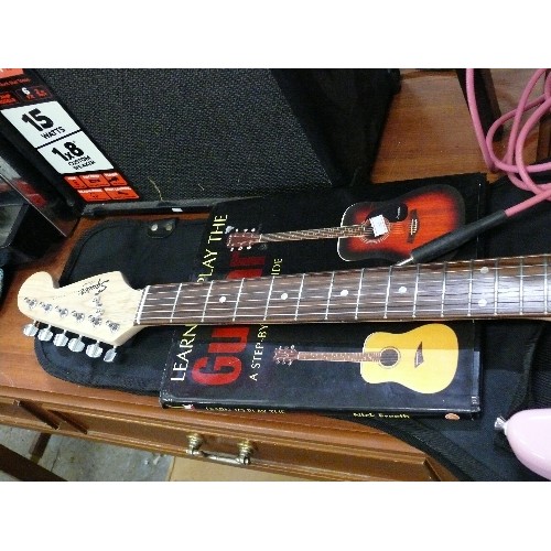 292 - STRATOCASTOR GUITAR BY SQUIRE AND PINK LEAD WITH ORIGINAL BOX, CARRY BAG AND PINK LEADS.  ALSO 'LEAR... 