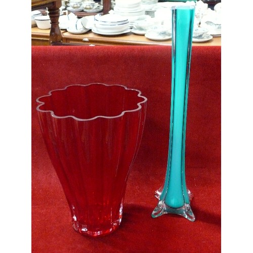 133 - LARGE HEAVY RED GLASS VASE PLUS TALL GREEN GLASS VASE.