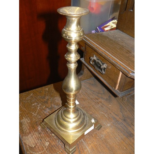 402 - LARGE VINTAGE BRASS CANDLESTICK ON SQUARE BASE WITH BRACKET FEET.