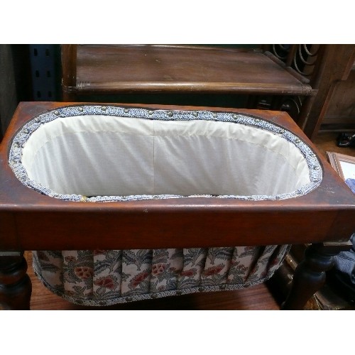 404 - A Victorian mahogany sewing box on turned legs with pleated fabric storage section