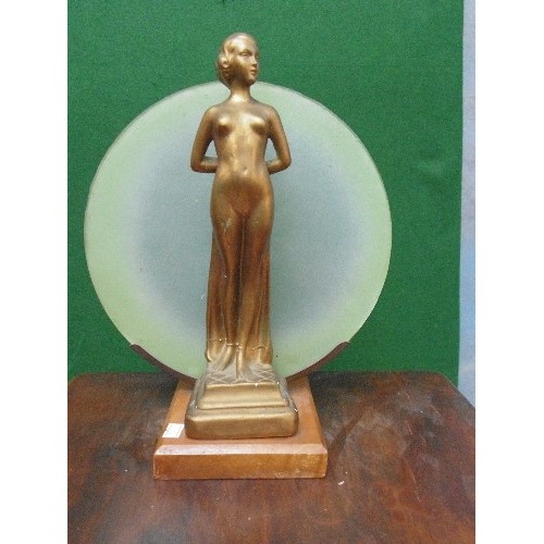 228 - An Art Deco nude lady figure in gilt finish with green glass disc behind - originally a lamp. Repair... 