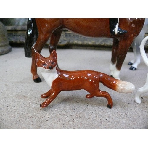 10 - A superb Beswick Hunting Group comprising Huntsman on bay horse, Huntswoman on dapple grey, five hou... 