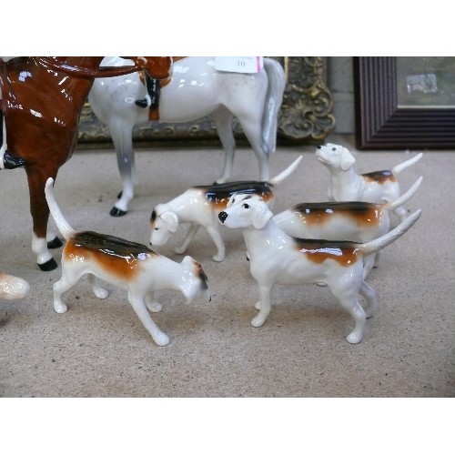 10 - A superb Beswick Hunting Group comprising Huntsman on bay horse, Huntswoman on dapple grey, five hou... 