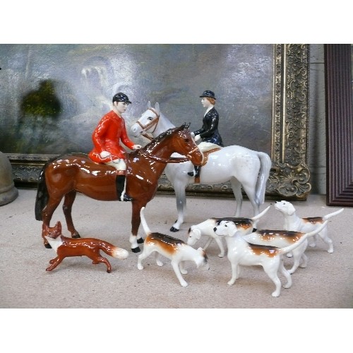 10 - A superb Beswick Hunting Group comprising Huntsman on bay horse, Huntswoman on dapple grey, five hou... 