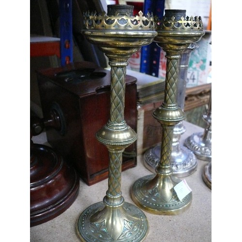 137 - A pair of Victorian Gothic candlesticks in brass, in the style of Augustus Pugin - 28cm