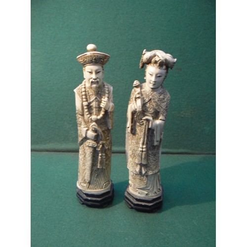 195A - A pair of Chinese resin figures of an Emperor and Empress, simulating ivory, 26cm H.