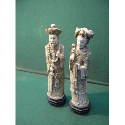 195A - A pair of Chinese resin figures of an Emperor and Empress, simulating ivory, 26cm H.