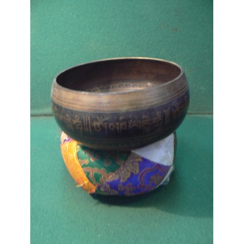 5 - A good 20th Century graduated set of Tibetan patinated brass singing bowls with cushions and mallets... 