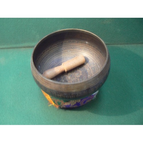 5 - A good 20th Century graduated set of Tibetan patinated brass singing bowls with cushions and mallets... 