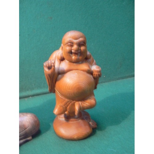 225 - A carved wooden figure of the seated buddha (20cm) and a carved wood laughing Buddha (16cm).