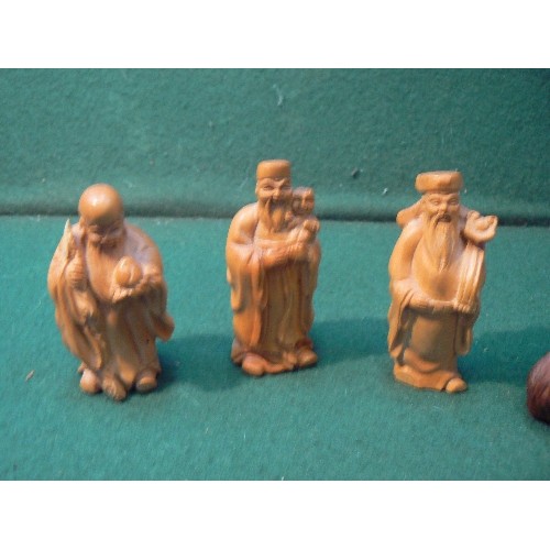 223 - Three carved wooden miniature figures of Chinese immortals and a Japanese netsuke of a mountain goat... 