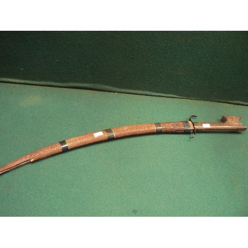 202 - A vintage Moroccan short sword. The blade with chiseled decoration -iron guard and shaped wooden hil... 