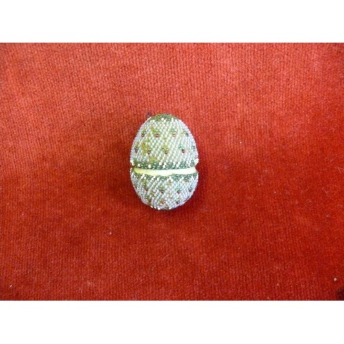 60 - A mid victorian beadwork covered carved bone egg containing a set of miniature bone dominoes