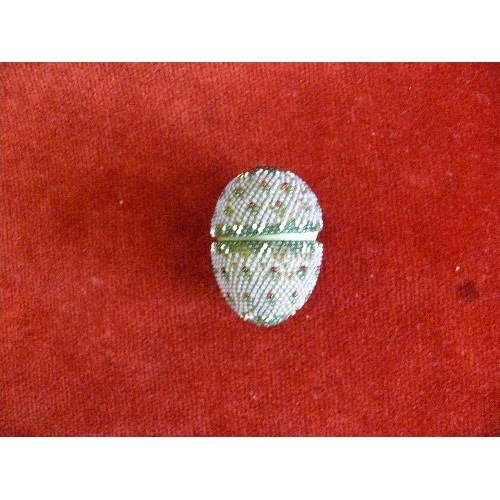 60 - A mid victorian beadwork covered carved bone egg containing a set of miniature bone dominoes