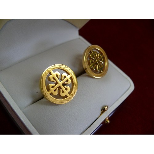 35 - A pair of Patek Philippe cufflinks with their calatrava cross logo, engraved 