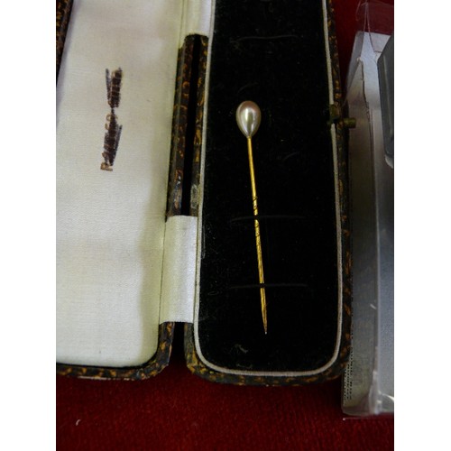 17 - An antique stick pin with simulated pearl in an old box together with a music box motor playing Rock... 