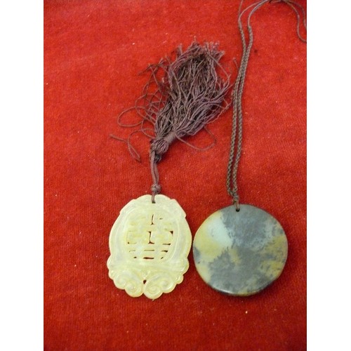 67 - Two vintage Chinese jade disc pendants, one in pale green jade with Chinese calligraphy, the other i... 