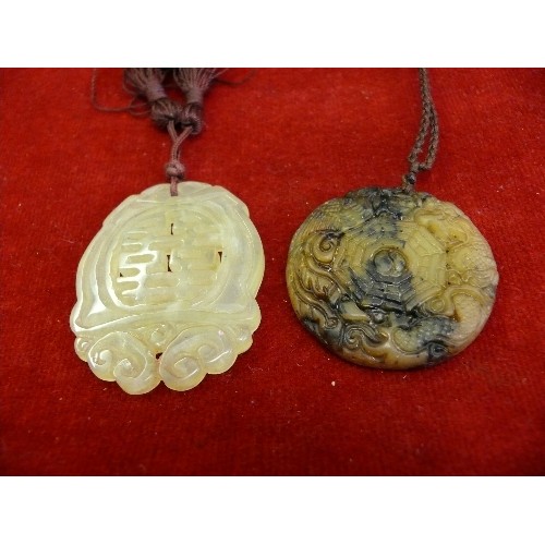 67 - Two vintage Chinese jade disc pendants, one in pale green jade with Chinese calligraphy, the other i... 