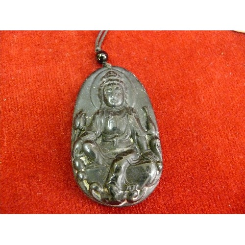 69 - Four 20th Century Chinese carved pendants including a jade buddha, a jade disc with brass dragon det... 