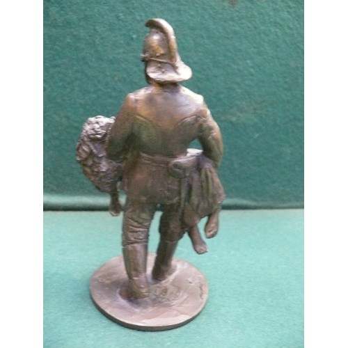 215 - A solid bronze figure of a fireman carrying a child. Well cast piece. Indistinct rubbed marks to the... 