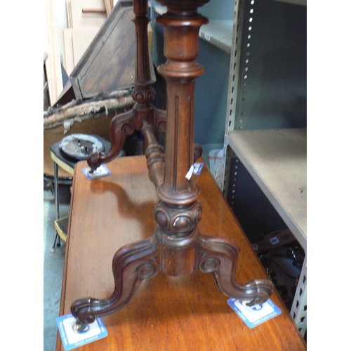 405 - A mid Victorian mahogany side table with turned stretcher on original white pot castors