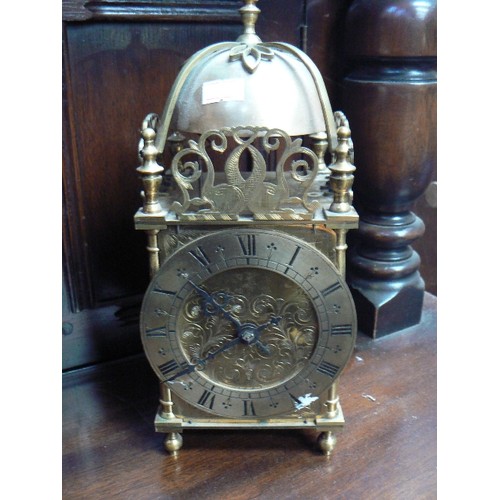 416 - A large brass striking lantern clock, circa 1920 with French movement in a London made case. With ke... 