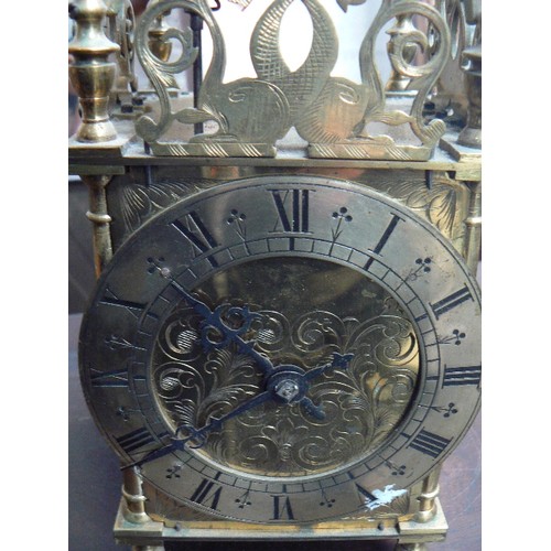 416 - A large brass striking lantern clock, circa 1920 with French movement in a London made case. With ke... 