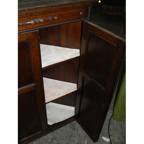 420 - 1920's oak corner cupboard with panelled doors, rope beading and 2 shelves