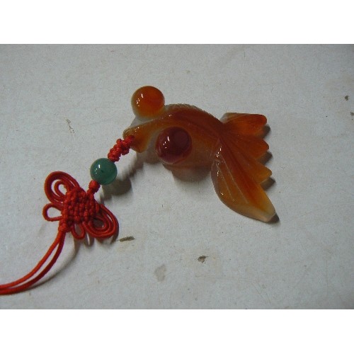 68 - An Oriental natural quartz stone fish on plaited toggle with jade bead and a sign of the zodiac pend... 