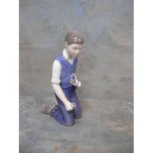 113 - A late 20th Century Danish Porcelain figure of a young man kneeling, with flowers, by Bing & Grondah... 