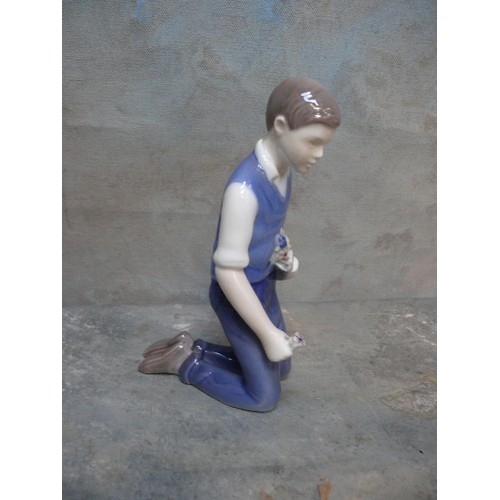 113 - A late 20th Century Danish Porcelain figure of a young man kneeling, with flowers, by Bing & Grondah... 