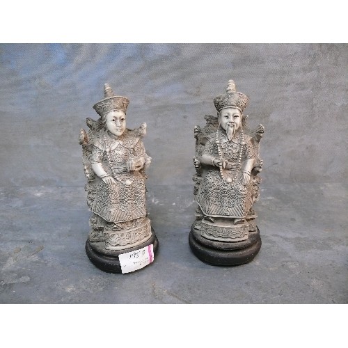 195B - A pair of Chinese resin figures of a seated Emperor and Empress, simulating ivory, 18cm H.