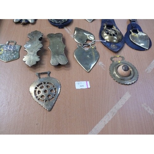 384 - Good selection of some unusual antique brasses, on straps and singles. Includes large stamped shell,... 