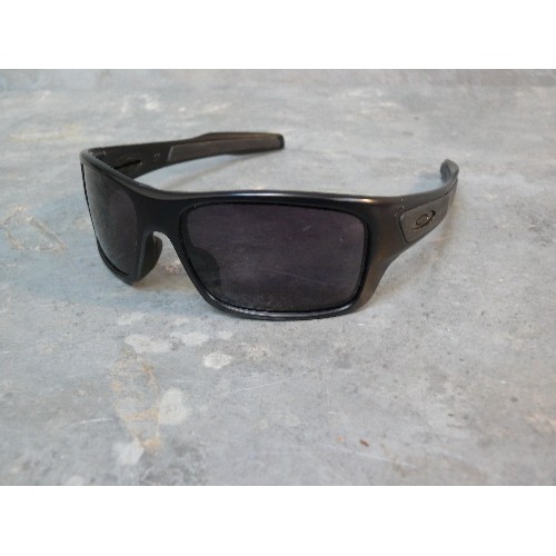 36A - Pair of designer sunglasses by Oakley with original soft case