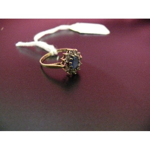 48 - A CLUSTER 9CT GOLD RING WITH BLUE STONE CENTRE AND WHITE STONES AROUND, ONE MISSING, WEIGHT 2GR.