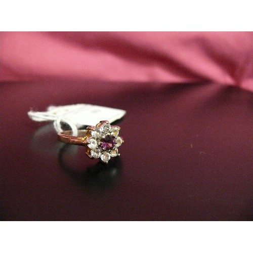 49 - A VINTAGE DRESS RING WITH LARGE RED STONE SURROUNDED BY WHITE STONES.