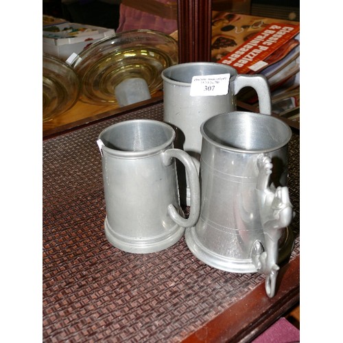 307 - THREE PEWTER TANKARDS