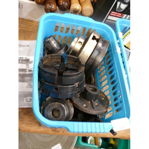 254 - BASKET OF THREE WOOD CHUCKS AND SEVERAL END PLATES FOR A LATHE.