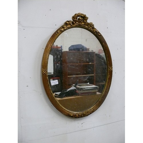 471 - OVAL MIRROR WITH ORNATE GILT FRAME.