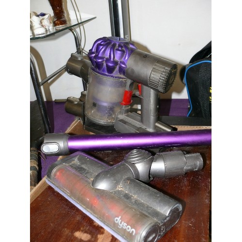 125 - DYSON HANDHELD RECHARGABLE VACUUM WITH ATTACHMENTS. spares as not charging