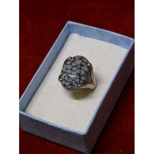 24 - A CONTEMPORARY STYLE STERLING SILVER RING SET WITH A LARGE OBSIDIAN CABOCHON - BIRMINGHAM HALLMARK -... 