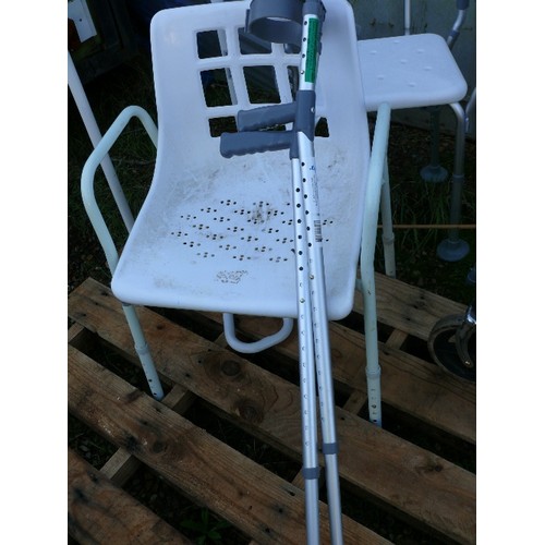 323 - THREE DISABILITY CHAIRS, A WALKER WITH BAG, PAIR OF CRUTCHES AND AN ADJUSTABLE WIDTH BEDSTICK.