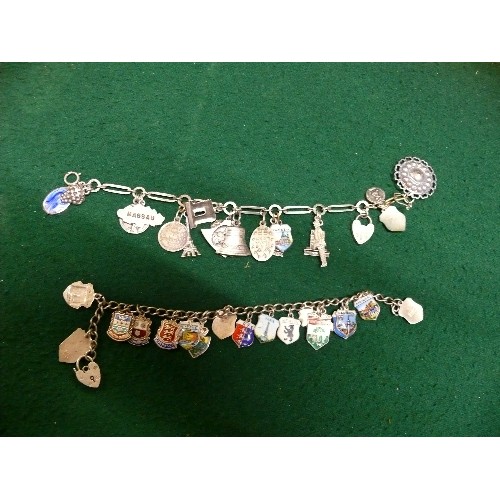 35 - TWO VINTAGE SOUVENIR CHARM BRACELETS, BOTH WITH HEART SHAPED CLASPS MARKED 'SILVER'. ONE WITH ENAMEL... 