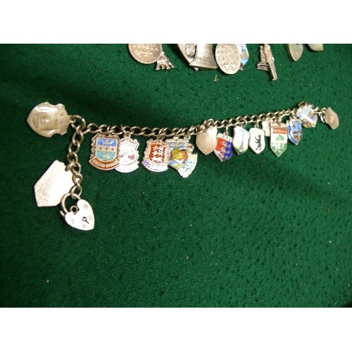 35 - TWO VINTAGE SOUVENIR CHARM BRACELETS, BOTH WITH HEART SHAPED CLASPS MARKED 'SILVER'. ONE WITH ENAMEL... 