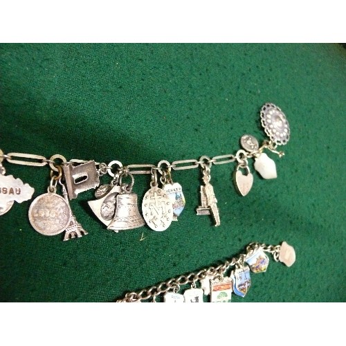 35 - TWO VINTAGE SOUVENIR CHARM BRACELETS, BOTH WITH HEART SHAPED CLASPS MARKED 'SILVER'. ONE WITH ENAMEL... 