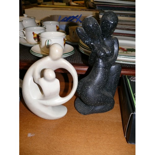 222 - TWO CONTEMPORARY FIGURES, ONE CREAM SOAPSTONE AND A BLACK MARBLE EFFECT COUPLE.